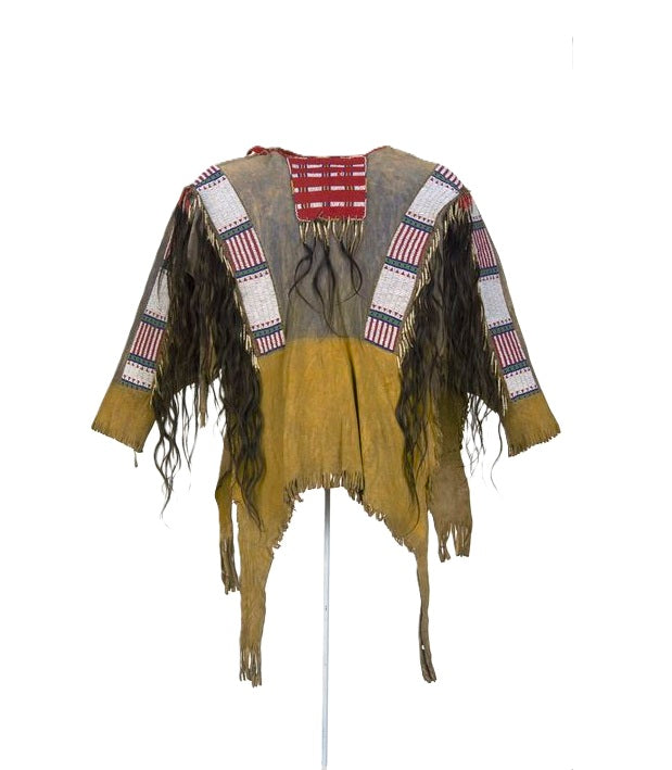 Traditional Native American garment with fringes and patterned vest on a white background