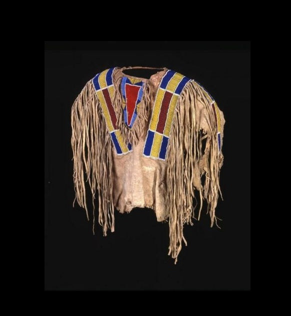 Traditional Native American headdress with fringes and colorful bandoliers on a black background
