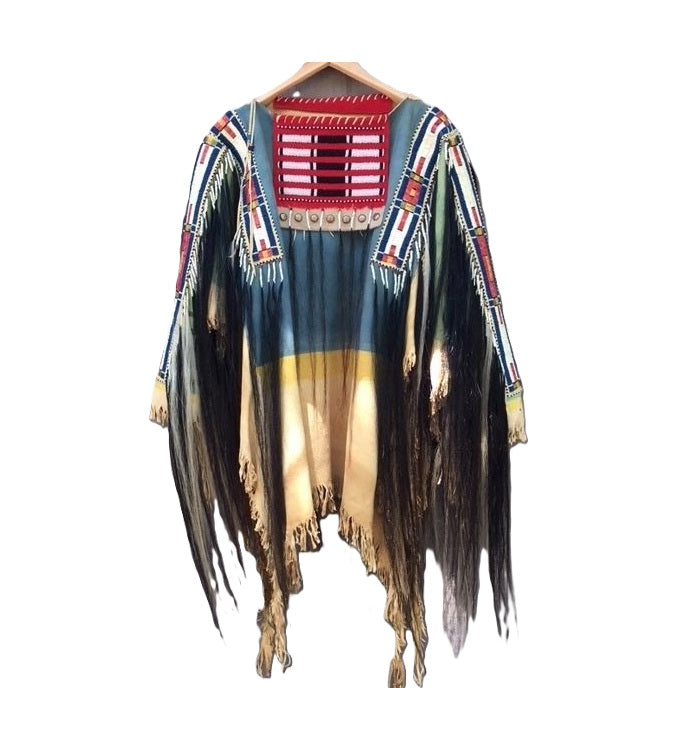 Colorful poncho with fringe details on a white background