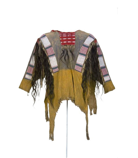 Traditional Native American garment with fringes and patterned vest on a white background