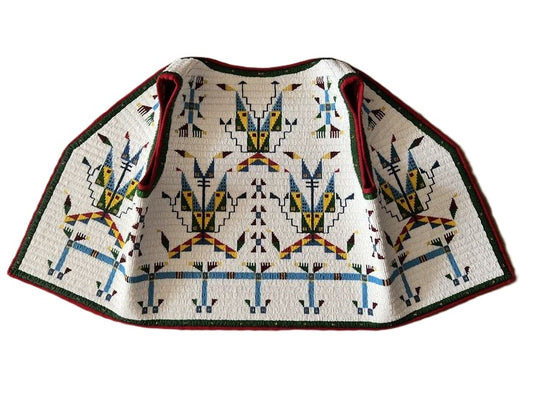Traditional patterned garment on a white background