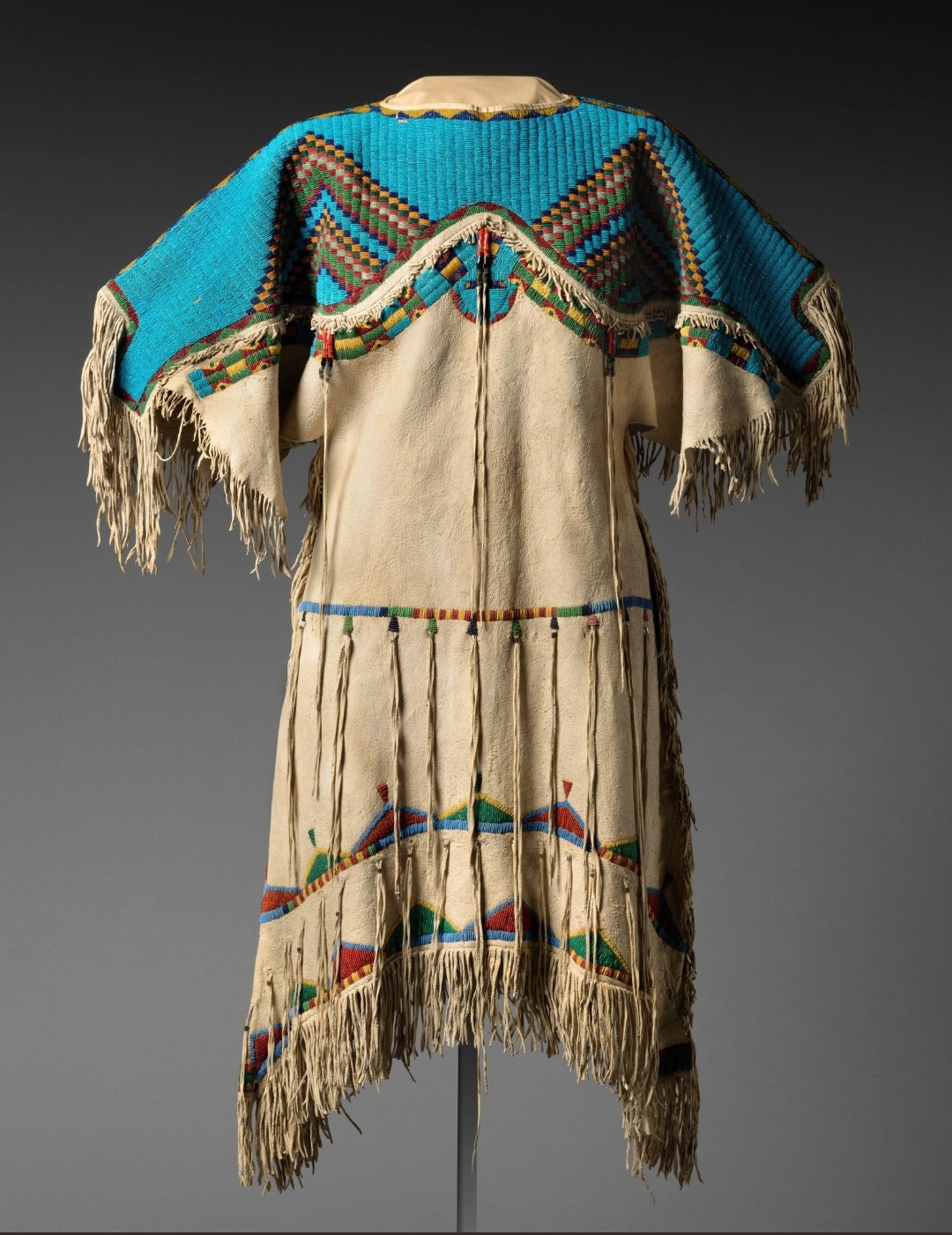Traditional Native American powwow garment with fringes and colorful patterns